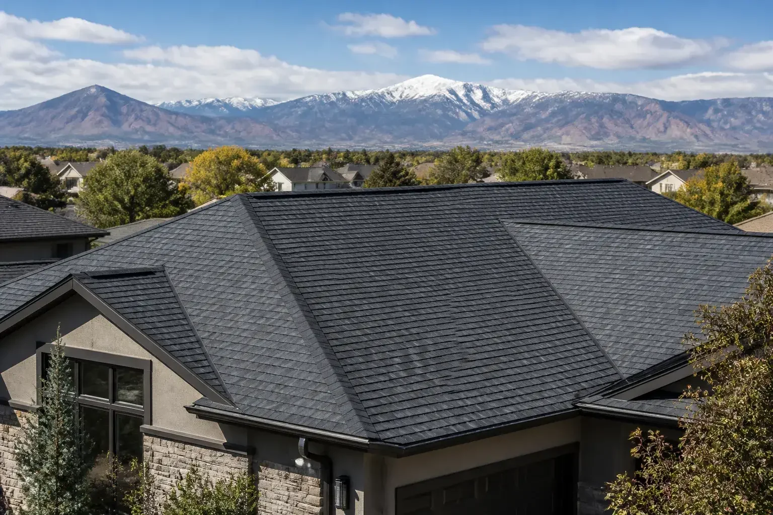 Finished Denver home roof with mountains in the background